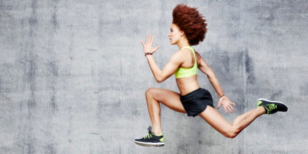 Woman jumping in air in urban studio