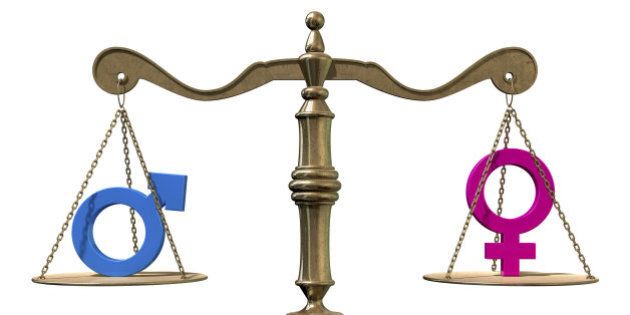 A gold justice scale with the two different gender symbols on either side balancing each other out on an isolated white background