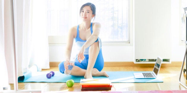 woman yoga alone with laptop at home