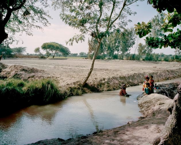 Without access to a clean water supply, people often resort to open sources for all their basic needs such as drinking and washing. Women and children are seen here bathing in an open steam, but this water is always a health risk; in many cases, it proves deadly.