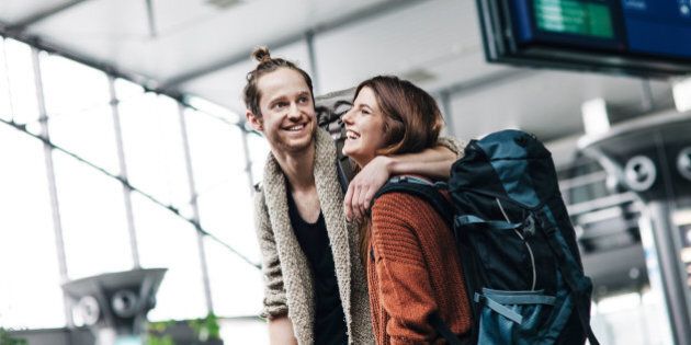 Young backpacker couple at airport