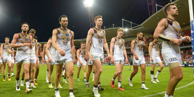 SYDNEY, AUSTRALIA - APRIL 30: Hawthorn Hawks show their dejection as they leave the field during the round six AFL match between the Greater Western Sydney Giants and the Hawthorn Hawks at Spotless Stadium on April 30, 2016 in Sydney, Australia. (Photo by Brett Hemmings/AFL Media/Getty Images)