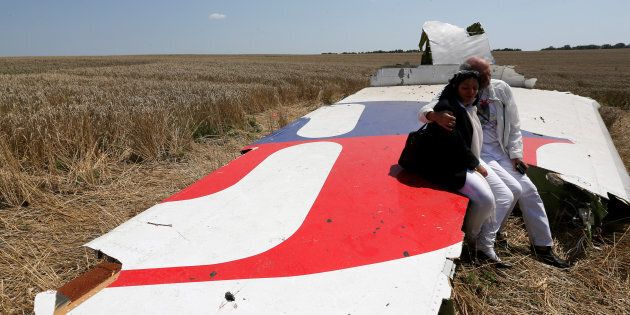 Debris from a Malaysian Airlines Boeing 777 that crashed on Thursday lies on the ground near the village of Rozsypne in the Donetsk region July 18, 2014. The Dutch are due to announce on Wednesday 28 September the long-awaited results of an investigation with Australia, Malaysia, Belgium and Ukraine into the July 17, 2014 downing of the flight. REUTERS/Maxim Zmeyev/File Photo FROM THE FILES PACKAGE - SEARCH