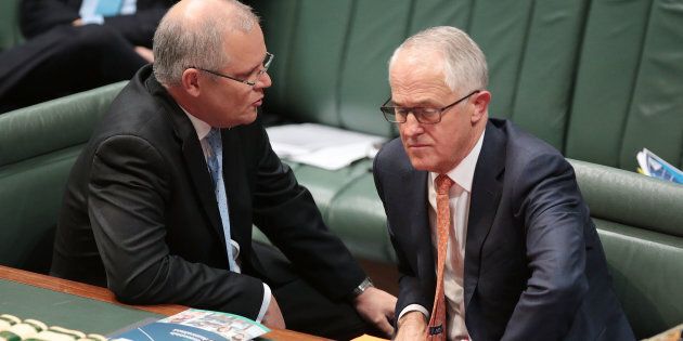 CANBERRA, AUSTRALIA - MAY 10: Treasurer Scott Morrison speaks to Prime Minister Malcolm Turnbull during question time at Parliament House on May 10, 2017 in Canberra, Australia. The Turnbull Government's second budget has delivered additional funds to education, a plan to assist first home buyers, along with a crackdown on welfare. (Photo by Stefan Postles/Getty Images)