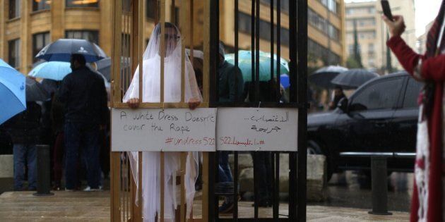 An activist from Abaad, a women's rights group in Lebanon, protests a law that shields rapists from prosecution on the condition that they marry their victim.