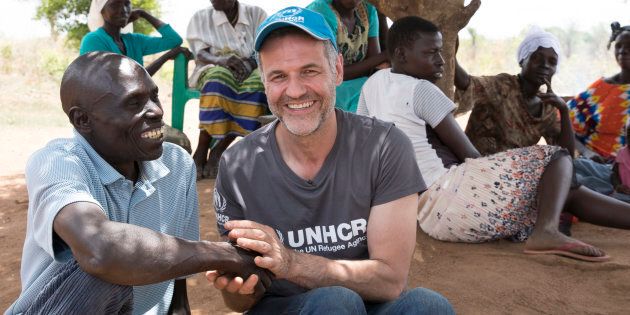 UNHCR Goodwill Ambassador Khaled Hosseini with Yahaya Onduga, a 51-year-old Ugandan farmer who has donated a plot of land to the family of a South Sudanese refugee.