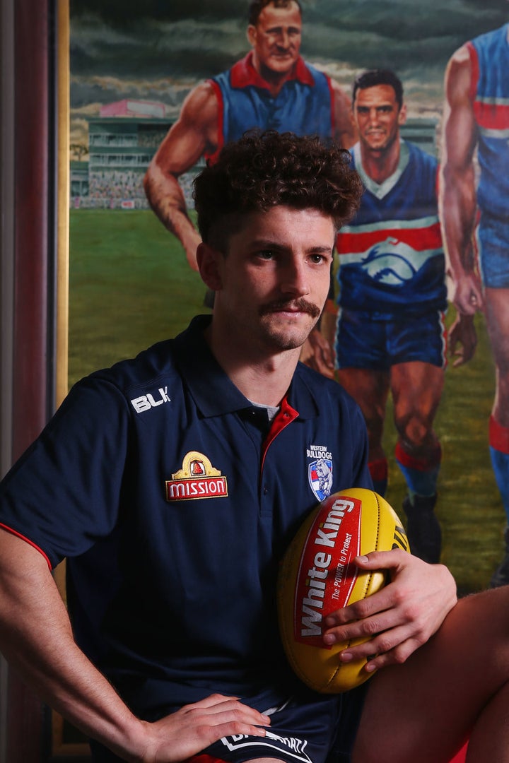 That's young Tom Liberatore with the footy, with dad Tony in the background.