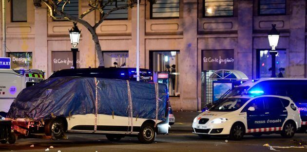 The van which ploughed into the crowd, killing at least 13 people and injuring around 100 others is towed away from the Rambla in Barcelona on August 18, 2017.