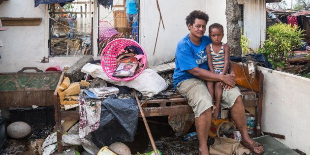 Kalisi holds her son Tuvosa, 3, in the remnants of her house in Rakiraki District in Ra province on February 24, 2016 in Fiji. Category 5 Tropical Cyclone Winston made landfall in Fiji on Saturday 20 February, continuing its path of destruction into Sunday 21 February.