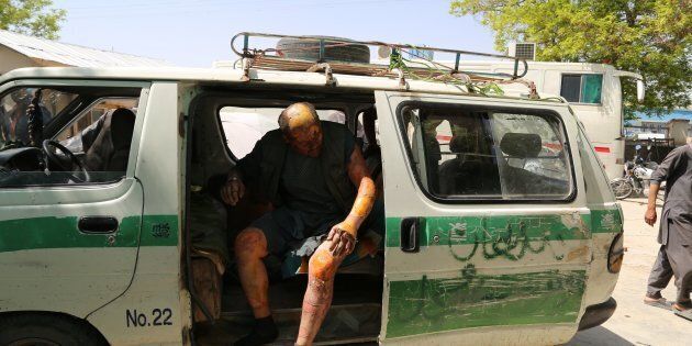 An injured man is seen in a vehicle after two buses and a fuel tanker collided on a major highway in the Ghazni province of Afghanistan on May 8, 2016.