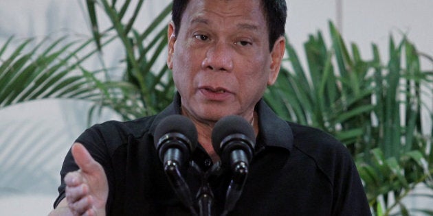 Philippines President Rodrigo Duterte gestures during a news conference upon his arrival from a state visit in Vietnam at the International Airport in Davao city, Philippines September 30, 2016. REUTERS/Lean Daval Jr