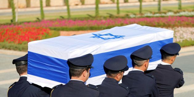 Members of the Knesset guard carry the flag-draped coffin of former Israeli President Peres.