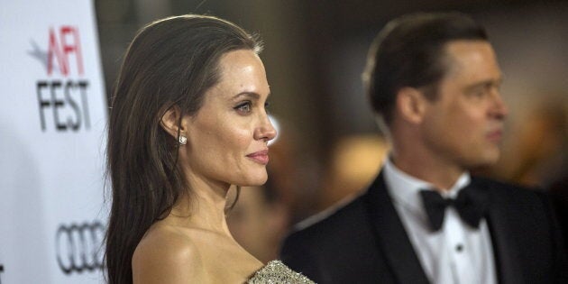 Director and cast member Angelina Jolie and her husband and co-star Brad Pitt pose at the premiere of