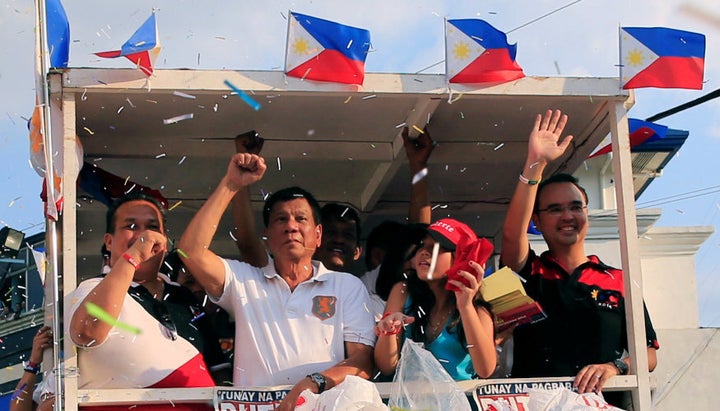 Rodrigo Duterte rides a motorcade through capital Manila.