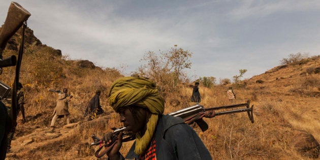 The Sudan Liberation Army led by Abdul Wahid (SLA-AW) climb towards the front lines in the last rebel-held territory in Central Darfur, Sudan, March 4, 2015.