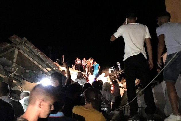 People are rescued from damaged buildings in Ischia. One person is dead and seven more are still missing.