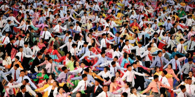 People participate in a mass dance in the capital's main ceremonial square, a day after the ruling Workers' Party of Korea party wrapped up its first congress in 36 years, in Pyongyang, North Korea, May 10, 2016. REUTERS/Damir Sagolj