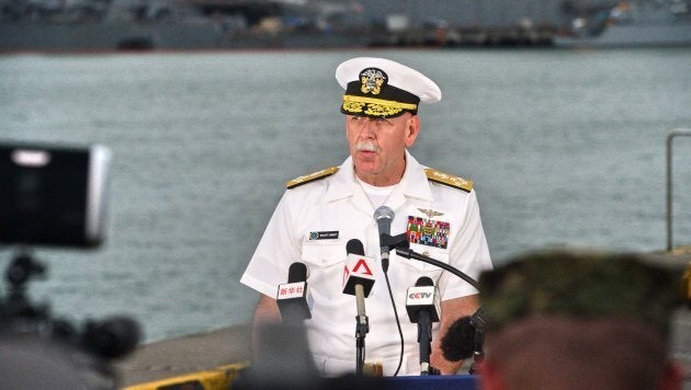 Admiral Scott Swift, commander of the U.S. Pacific Fleet, speaks to reporters during a press conference, as the guided-missile destroyer USS John S. McCain is seen in the background, at Changi naval base in Singapore.