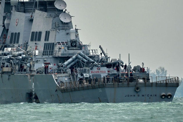 The guided-missile destroyer USS John S. McCain, with a hole on its portside after a collision with an oil tanker.