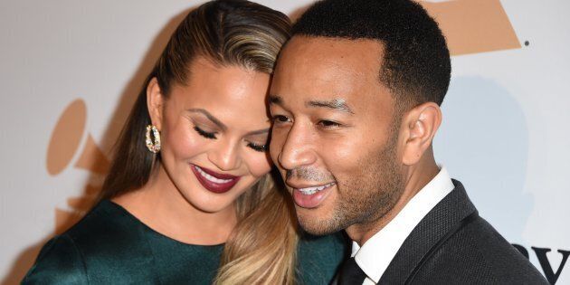 Singer-songwriter John Legend (R) and his wife Chrissy Teigen arrive for the Clive Davis & The Recording Academy's 2016 Pre-Grammy Gala in Beverly Hills, California, February 14, 2016. AFP PHOTO/ MARK RALSTON / AFP / MARK RALSTON (Photo credit should read MARK RALSTON/AFP/Getty Images)