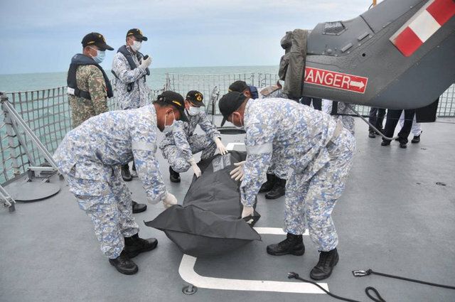Royal Malaysian Navy personnel carry a body onto their ship during a search and rescue operation for survivors of the USS John McCain ship collision in Malaysian waters in this undated handout released August 22, 2017. Royal Malaysian Navy Handout via REUTERS