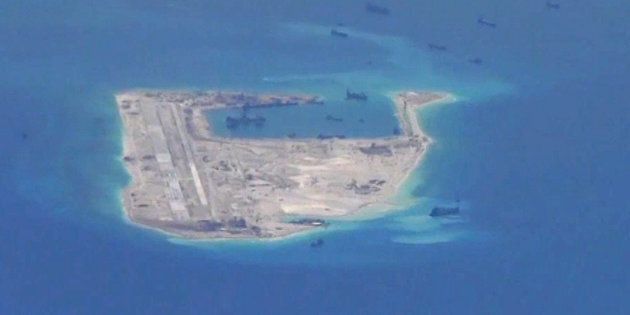 Chinese dredging vessels are purportedly seen in the waters around Fiery Cross Reef in the disputed Spratly Islands in the South China Sea in this still image from video taken by a P-8A Poseidon surveillance aircraft provided by the United States Navy May 21, 2015. U.S. Navy/Handout via Reuters/File Photo ATTENTION EDITORS - THIS PICTURE WAS PROVIDED BY A THIRD PARTY. EDITORIAL USE ONLY. TPX IMAGES OF THE DAY