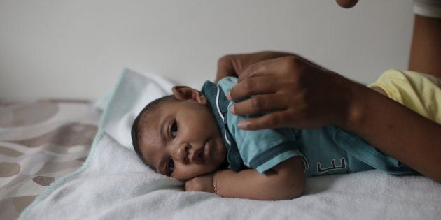 Mariam Araujo, 25, plays with Lucas, her 4-months old second child and born with microcephaly as they wait for a physiotherapy session in Pedro I hospital in Campina Grande, Brazil, February 17, 2016.