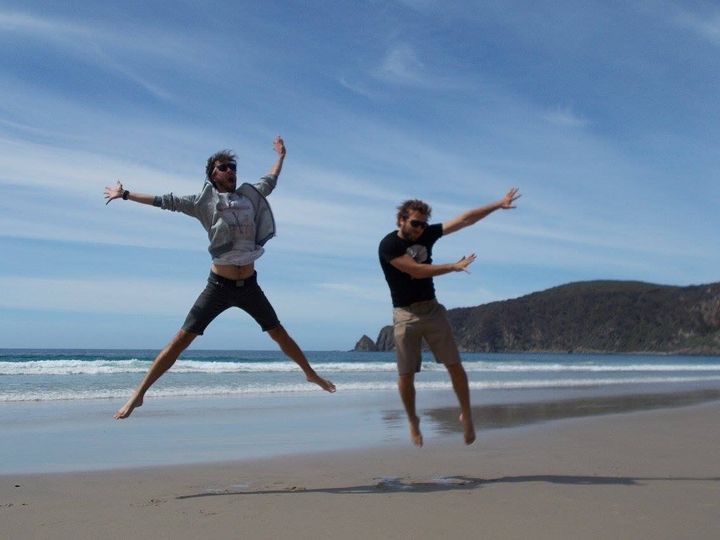 Jon and Sam jumping on Bruny Island beach.