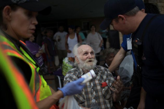 A man is assisted by medics as he is evacuated after losing his home to Hurricane Harvey in Rockport, Texas.