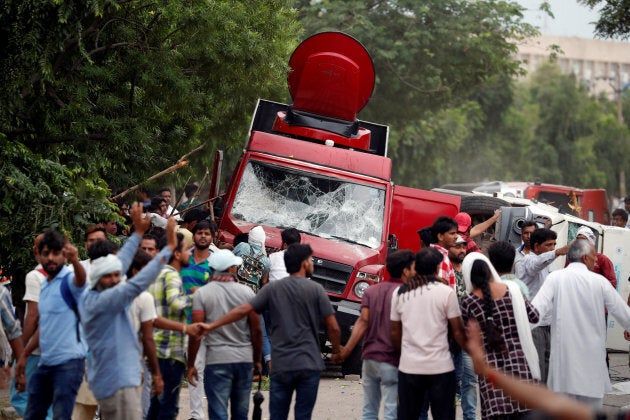 Rioters smash television trucks during violence in Panchkula, India.