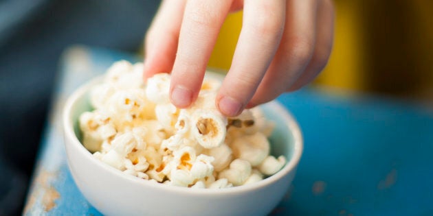 Hand reaching popcorn