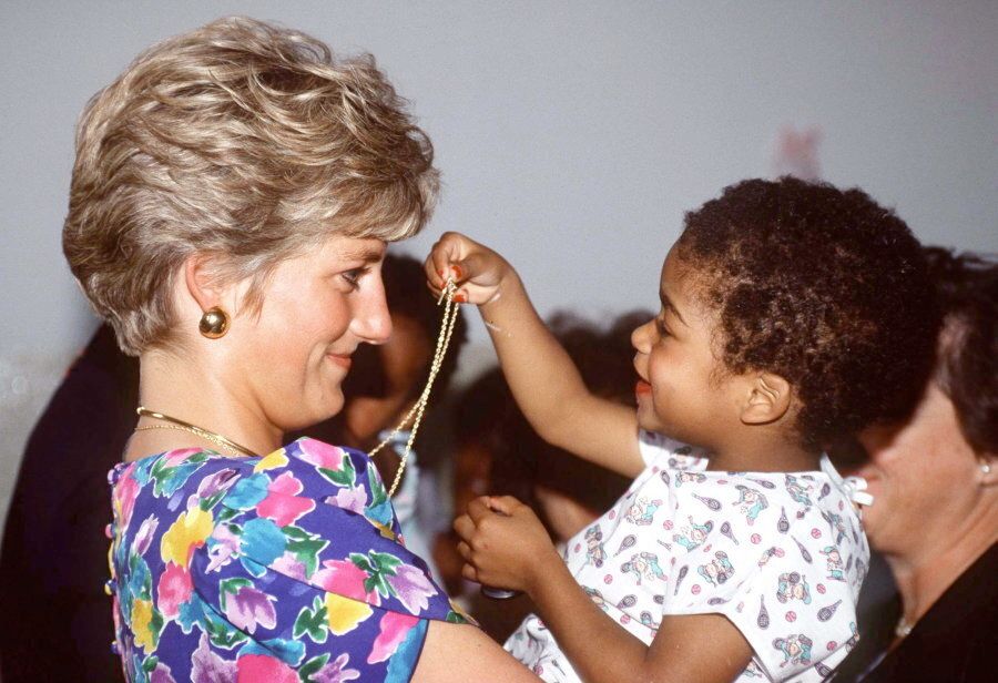 Diana holding a baby at a hostel for abandoned children In Sao Paolo, Brazil. The Hostel Cares for HIV-Positive Children.