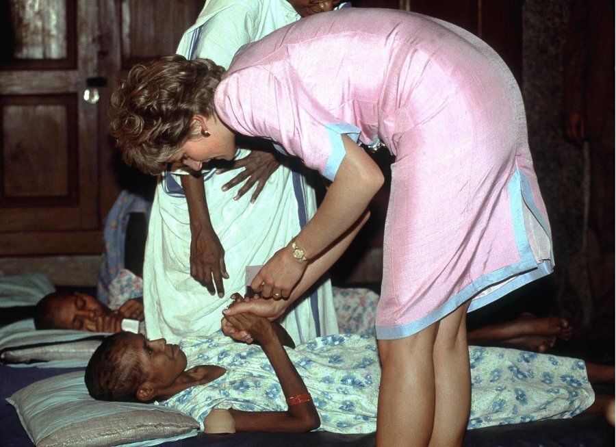 The Princess of Wales helping a patient at Mother Theresa's hospice in Calcutta, India, 15th February 1992.