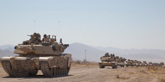 Abrams tanks train in the desert for the possibility of