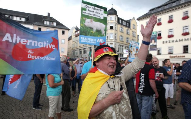 Alternative for Germany party supporters protest during the election rally of the German Chancellor Angela Merkel, a top candidate of the Christian Democratic Union Party (CDU), in Annaberg-Buchholz, Germany on August 17, 2017, ahead of the upcoming federal election.