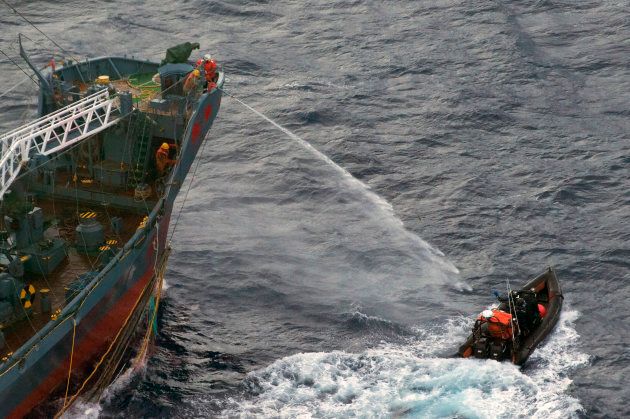 A water canon is sprayed from a Japanese whaling ship towards a small Sea Shepherd boat, about 480 km north of Mawson Peninsula off the coast of Antarctica, in this handout picture released on January 18, 2012.