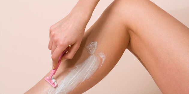 Woman shaving leg