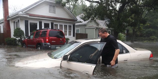 ST AUGUSTINE, FL - OCTOBER 07: Rob Birch checks on his car which floated out of his drive way as Hurricane Matthew passes through the area on October 7, 2016 in St Augustine, Florida. Florida, Georgia, South Carolina and North Carolina all declared a state of emergency in anticipation of Hurricane Matthew. (Photo by Joe Raedle/Getty Images)