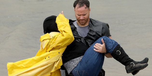 HOUSTON, TX - AUGUST 29: A volunteer carries a woman whose home was impacted by severe flooding following Hurricane Harvey in north Houston August 29, 2017 in Houston, Texas. Parts of southeast Texas have received more than 40 inches of rain since Harvey made landfall on Friday, with more torrential rain expected the next several days. (Photo by Win McNamee/Getty Images)