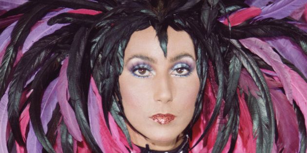 Promotional portrait of American singer and actress Cher (born Cherilyn Sarkisian LaPiere) in a semi-transparent outfit with a feathered headdress for the television variety show 'The Sonny and Cher Comedy Hour,' 1972. (Photo by CBS Photo Archive/Getty Images)