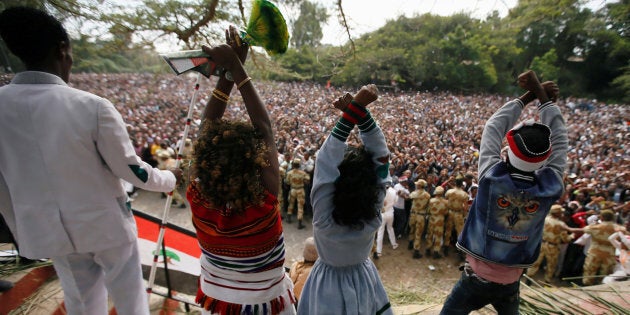 Demonstrators chant slogans while flashing the Oromo protest gesture during Irreecha, the thanksgiving festival of the Oromo people, in Bishoftu town, Oromia region, Ethiopia, October 2, 2016.