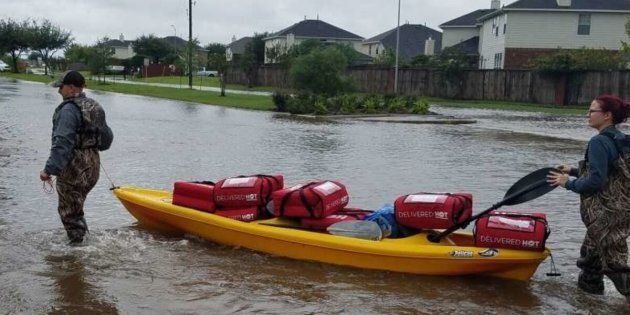 Pizza Hut employees deliver pizzas to flooded homes in southeast Texas this week.