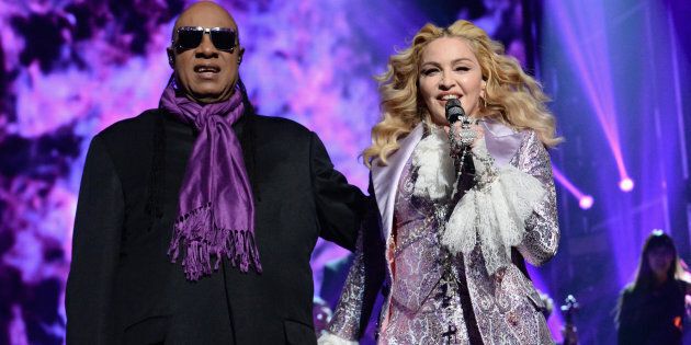 Stevie Wonder and Madonna perform a tribute to Prince onstage during the 2016 Billboard Music Awards.