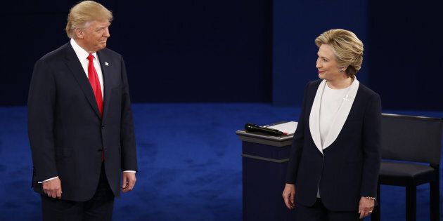 Donald Trump, 2016 Republican presidential nominee, and Hillary Clinton, 2016 Democratic presidential nominee, arrive on stage during the second U.S. presidential debate at Washington University in St. Louis, Missouri, U.S., on Sunday, Oct. 9, 2016. As has become tradition, the second debate will resemble a town hall meeting, with the candidates free to sit or roam the stage instead of standing behind podiums, while members of the audience -- uncommitted voters, screened by the Gallup Organization -- will ask half the questions. Photographer: Andrew Harrer/Bloomberg via Getty Images