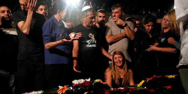 Relatives and friends mourn over the grave of Israeli policeman in Jerusalem October 9, 2016.
