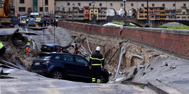 A road in central Florence collapsed on Wednesday, causing some 20 cars to fall into a ditch and cutting off water supply to parts of the city.