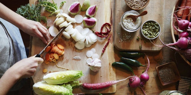 A woman prepares fresh veggies.