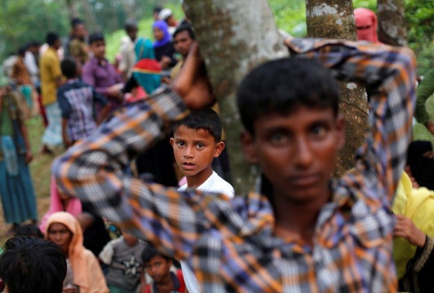 Rohingya refugees wait near Kutupalong refugee camp after crossing the Bangladesh-Myanmar border.