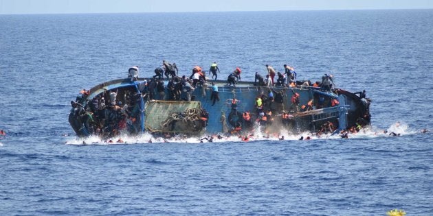 An overcrowded migrant boat shortly before capsizing in the Mediterranean Sea between Libya and Italy on Wednesday. The Italian navy rescued over 500 passengers but several drowned.