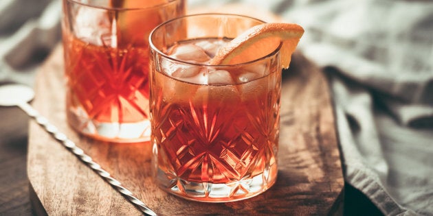 Two glasses of cocktail with orange slice. Toned image